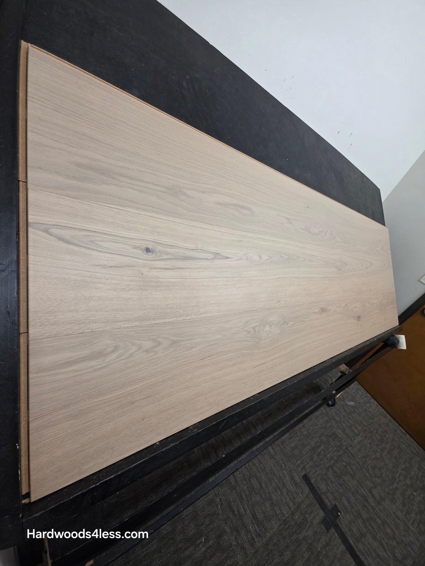 10.67" x 7/16" Modernized Engineered European Oak Foster Hardwood Flooring. Shown on a black shooting table, shot from steep left. This is a Laminate look alike.
