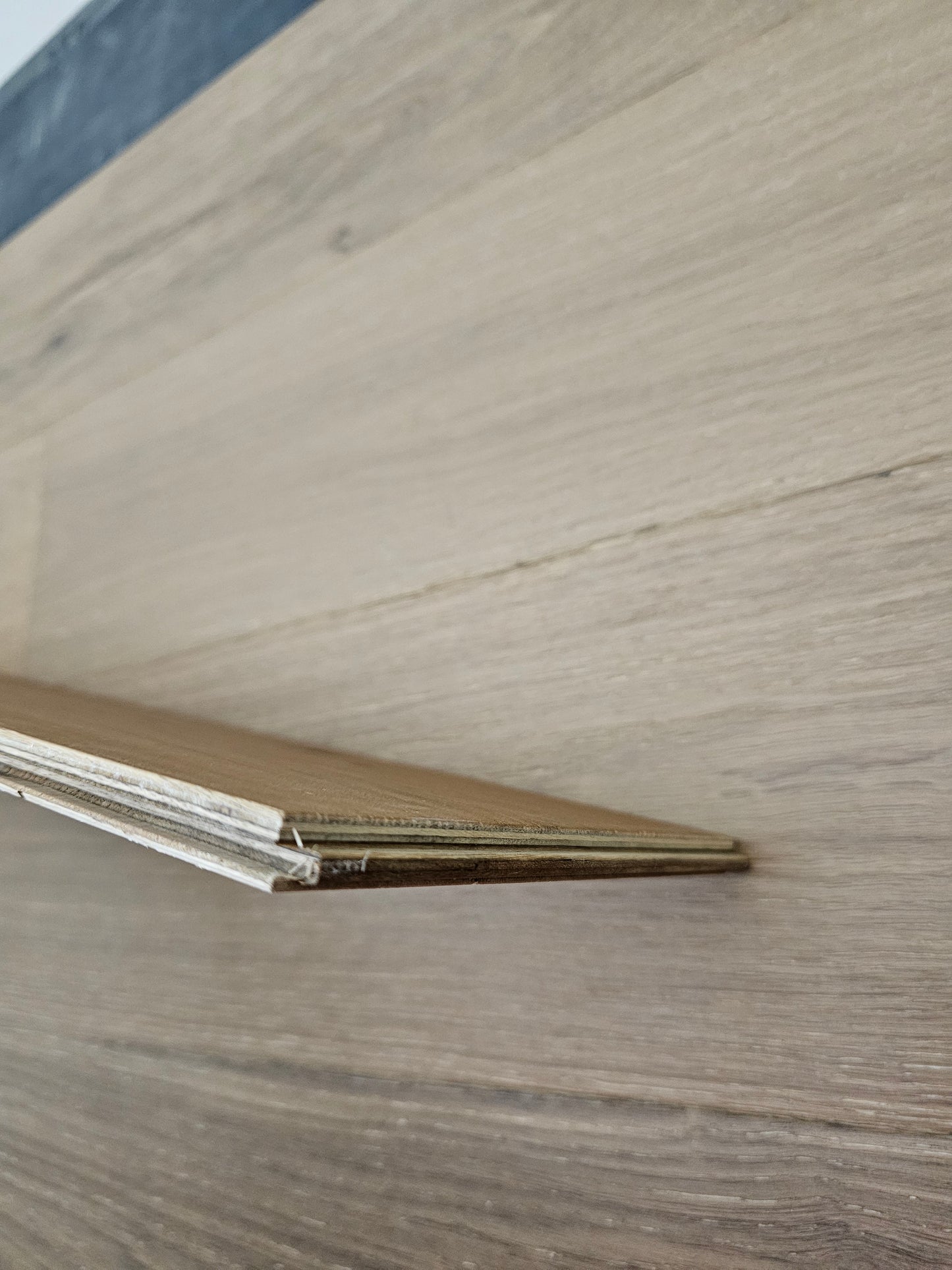 7 1/2" x 1/2" Engineered White Oak Hunter Hardwood Flooring. Close up of the wear layer over the floor.