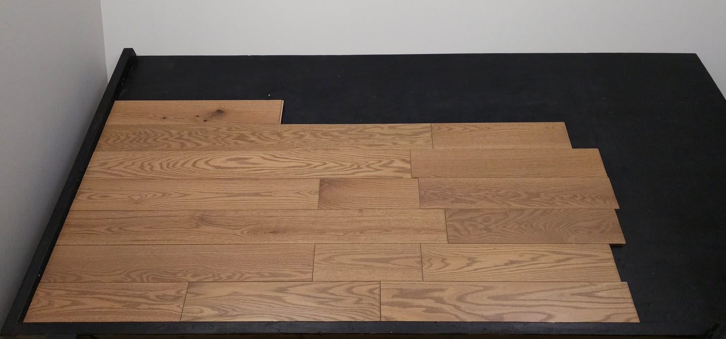Solid Red Oak Marcy Hardwood Flooring straight on shot on a black rack