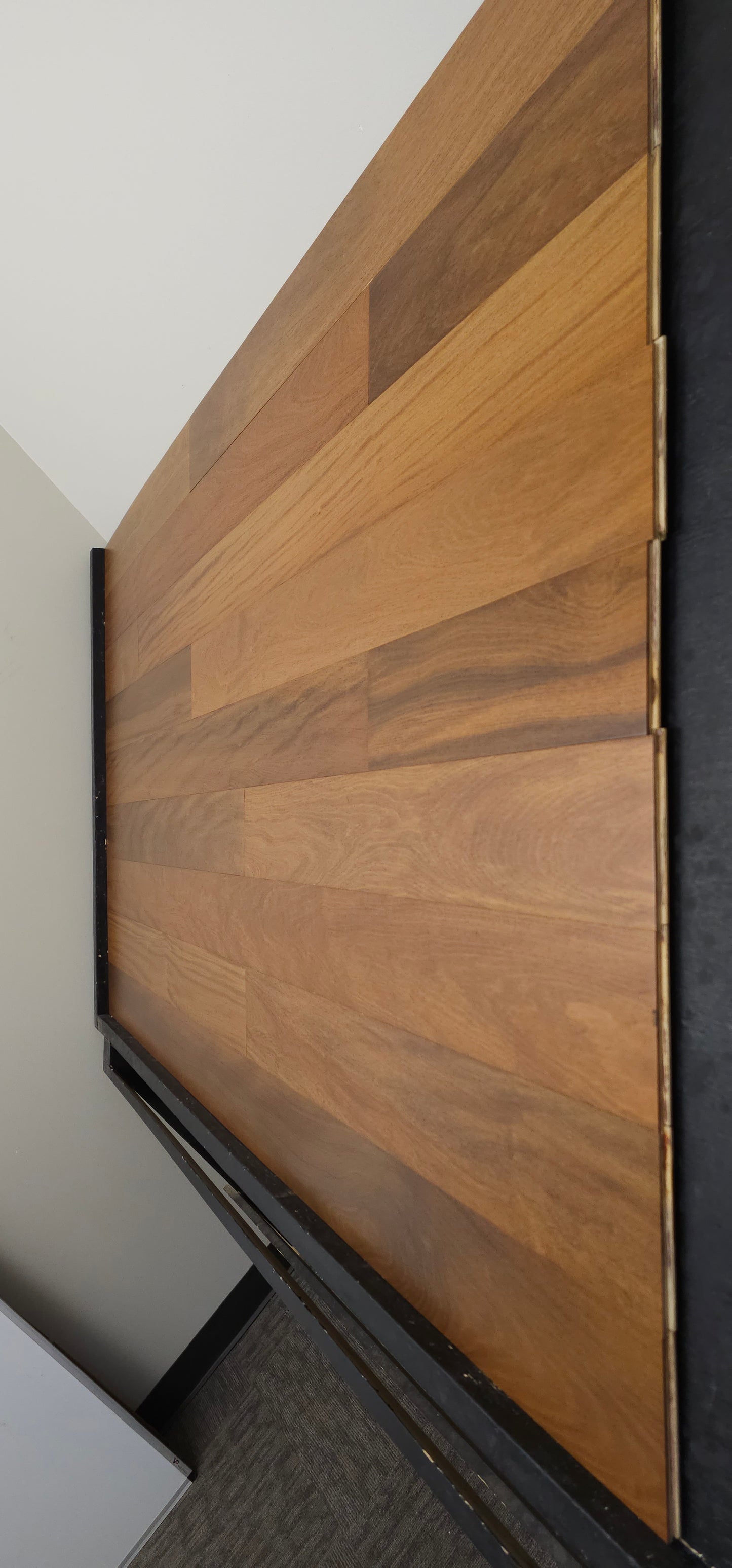 Brazilian Teak Hardwood Flooring shown on a black shooting table
