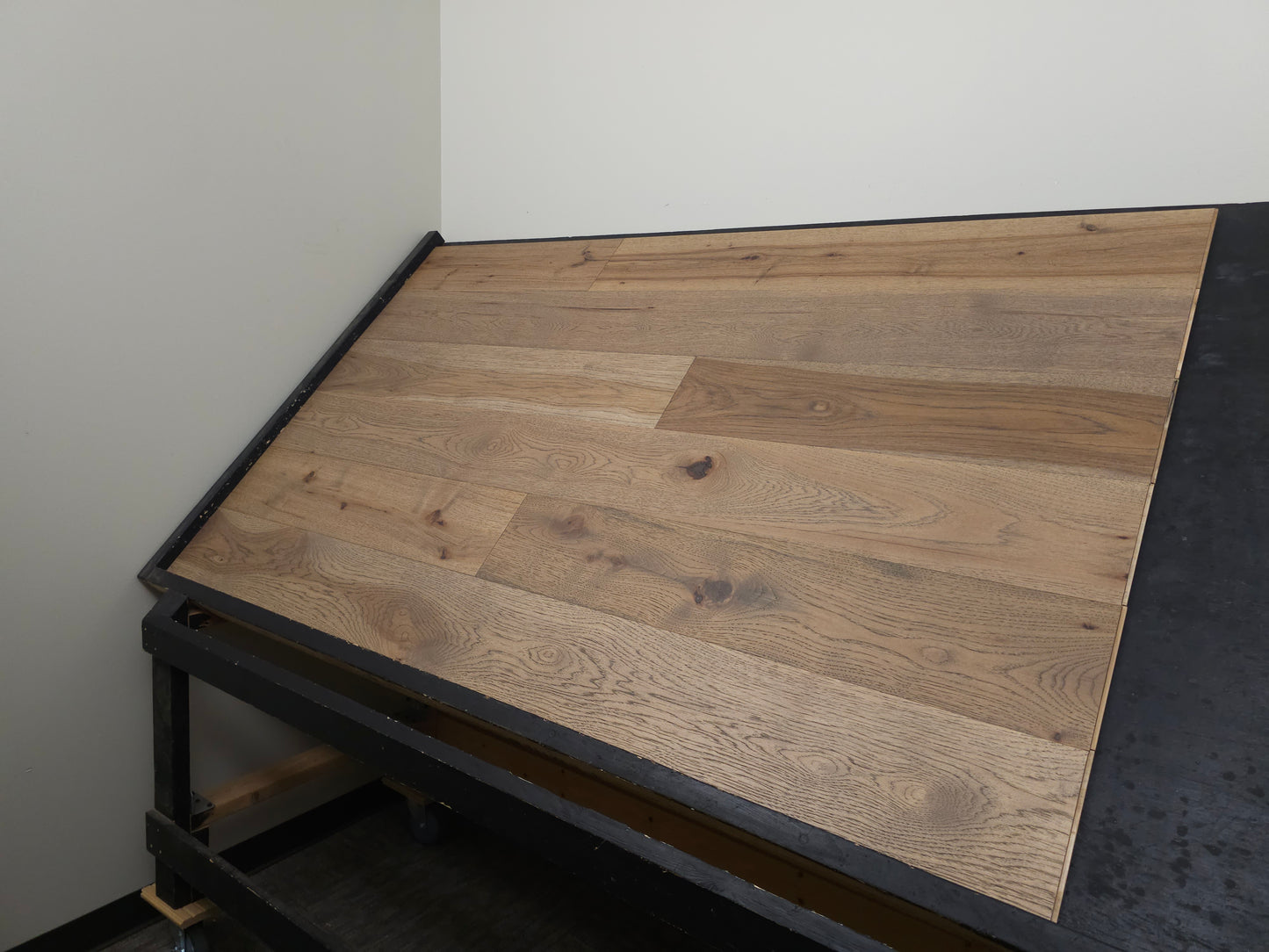 7 1/2" x 5/8" Engineered Hickory Beargrass Hardwood Flooring shown on a black shooting table shot from wide right.