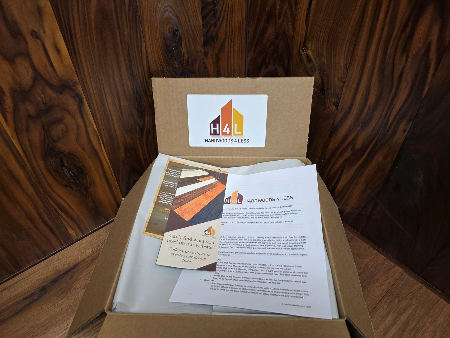 Hardwood Flooring sample box with brochures on a wooden surface