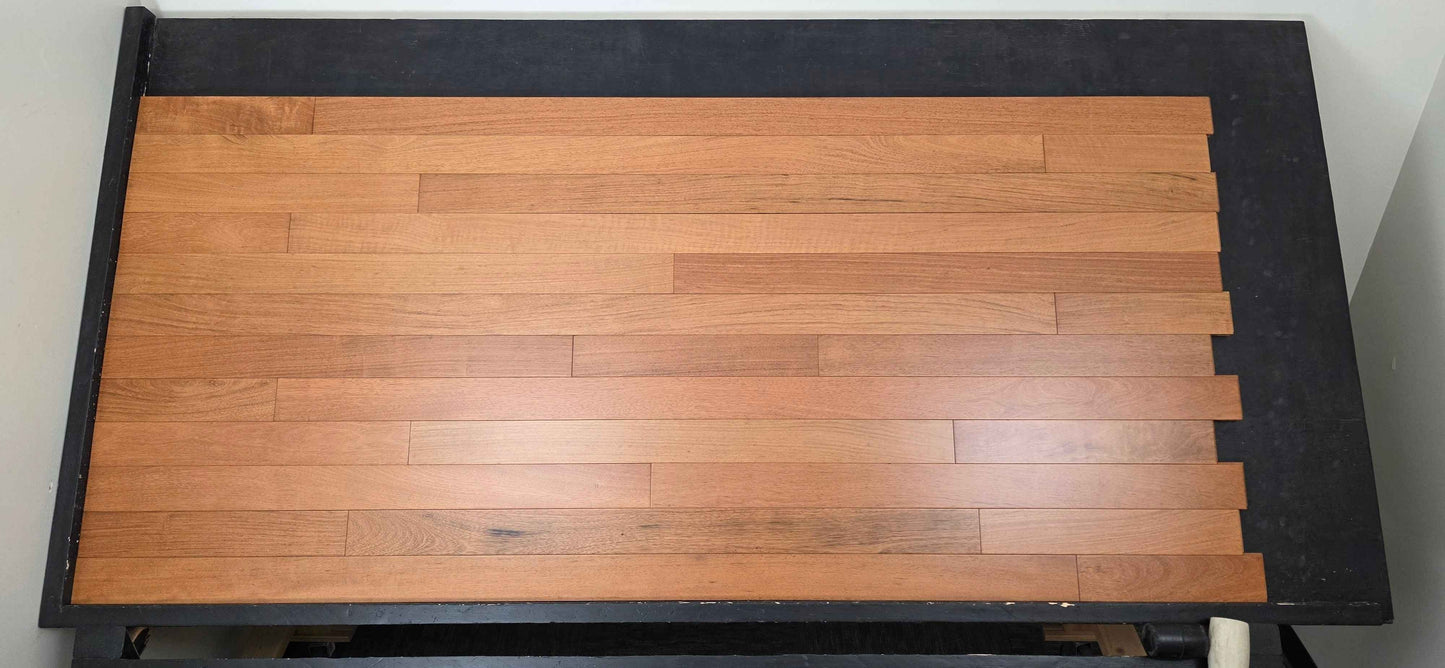 3 1/4" x 3/4" Prefinished Brazilian Cherry Shorts Hardwood Flooring shown on a black shooting table. Shot from center.