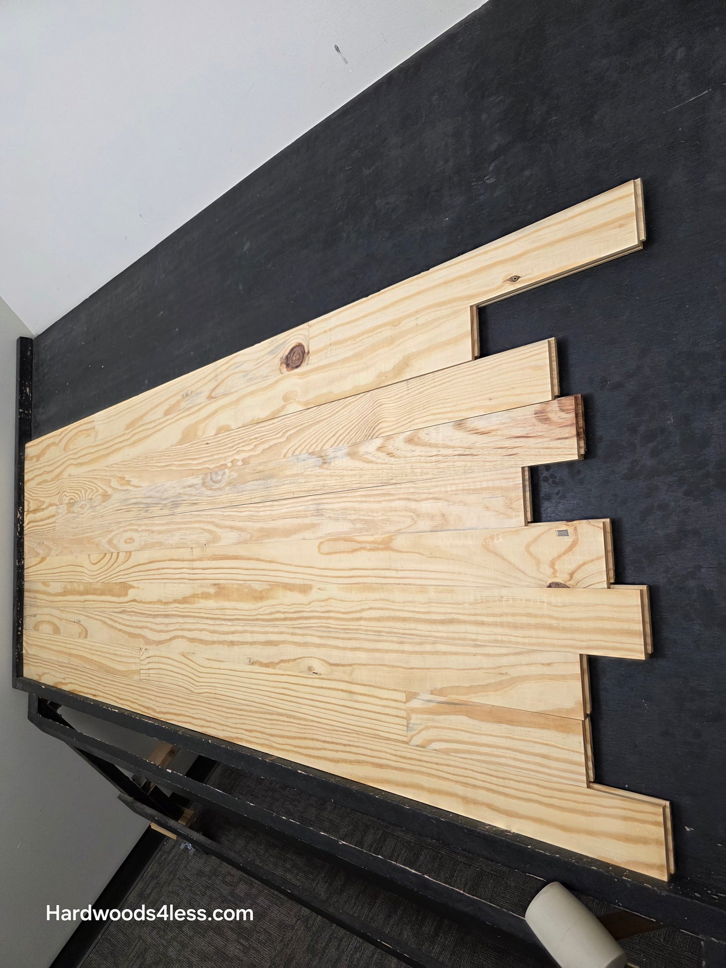 3 1/8" x 3/4" Unfinished Southern Yellow Pine Solid Hardwood Flooring. Shown on a black shooting table shot from the right hand side.