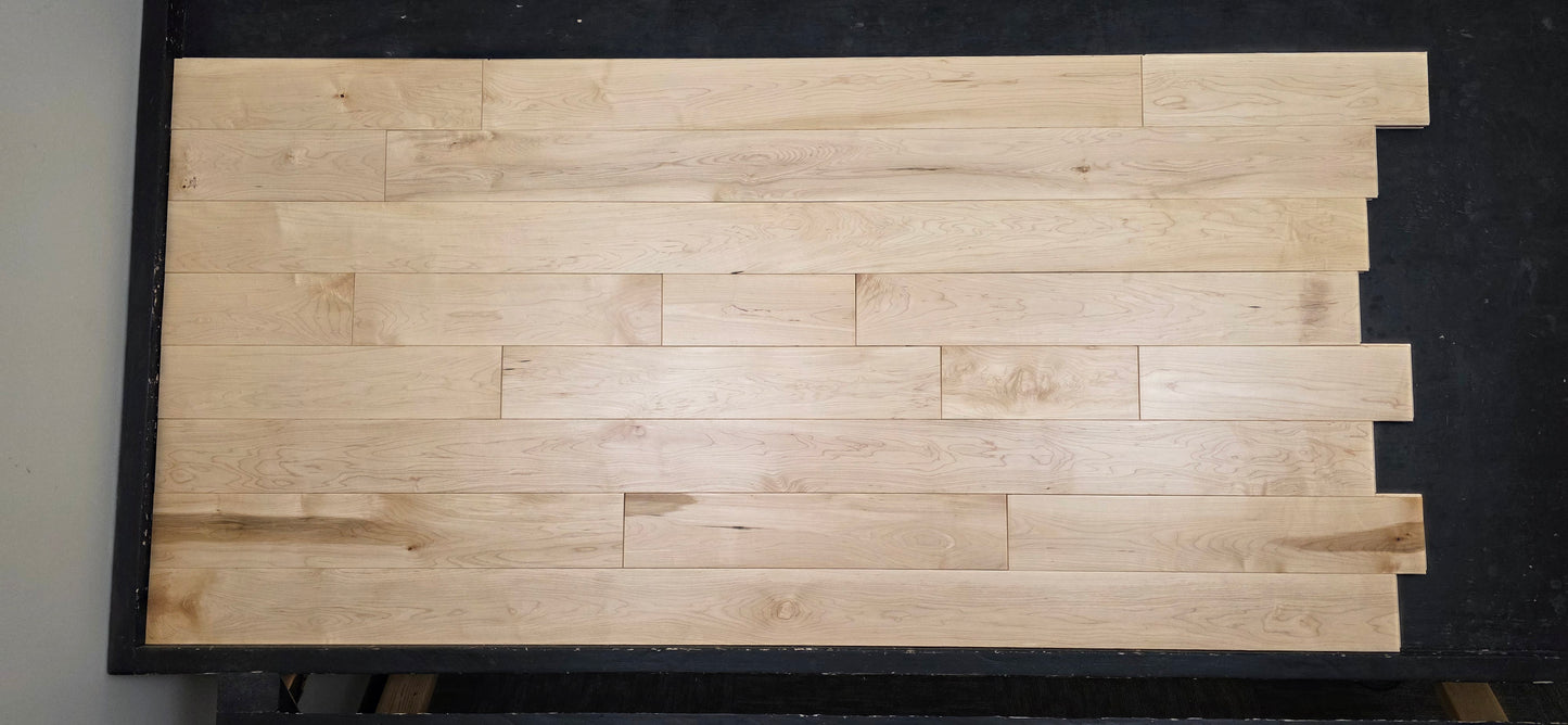Maple HardWood flooring with a light brown color and visible grain pattern.