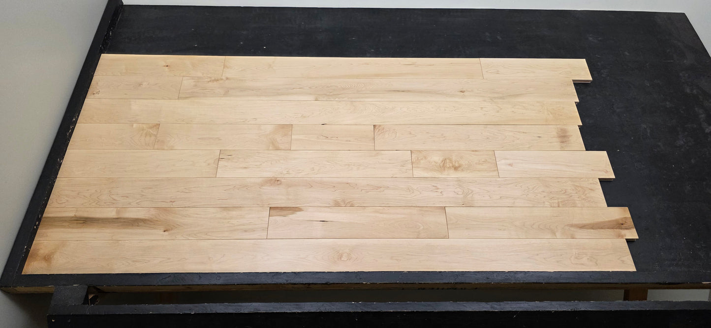 Maple HardWood flooring with a light brown color and visible grain pattern.