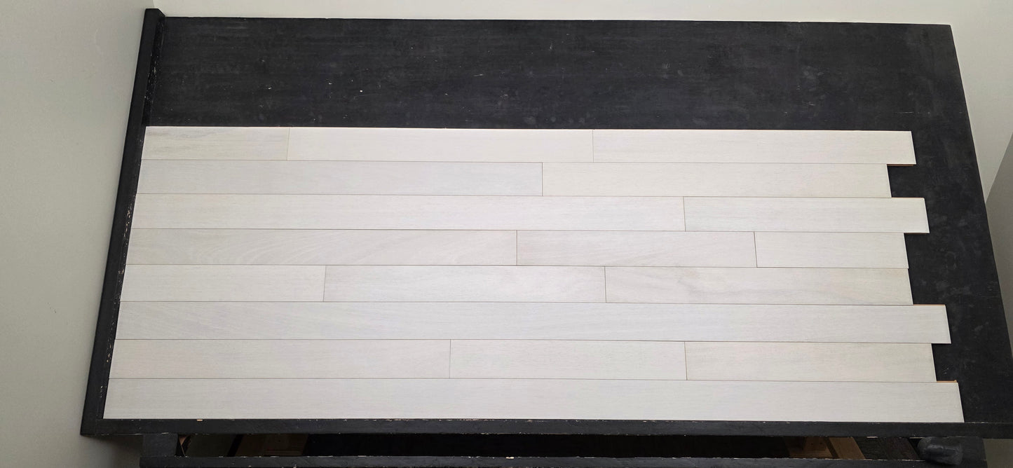 4" x 3/4" Solid Brazilian Oak Urso Hardwood Flooring on a black shooting table, head on shot.
