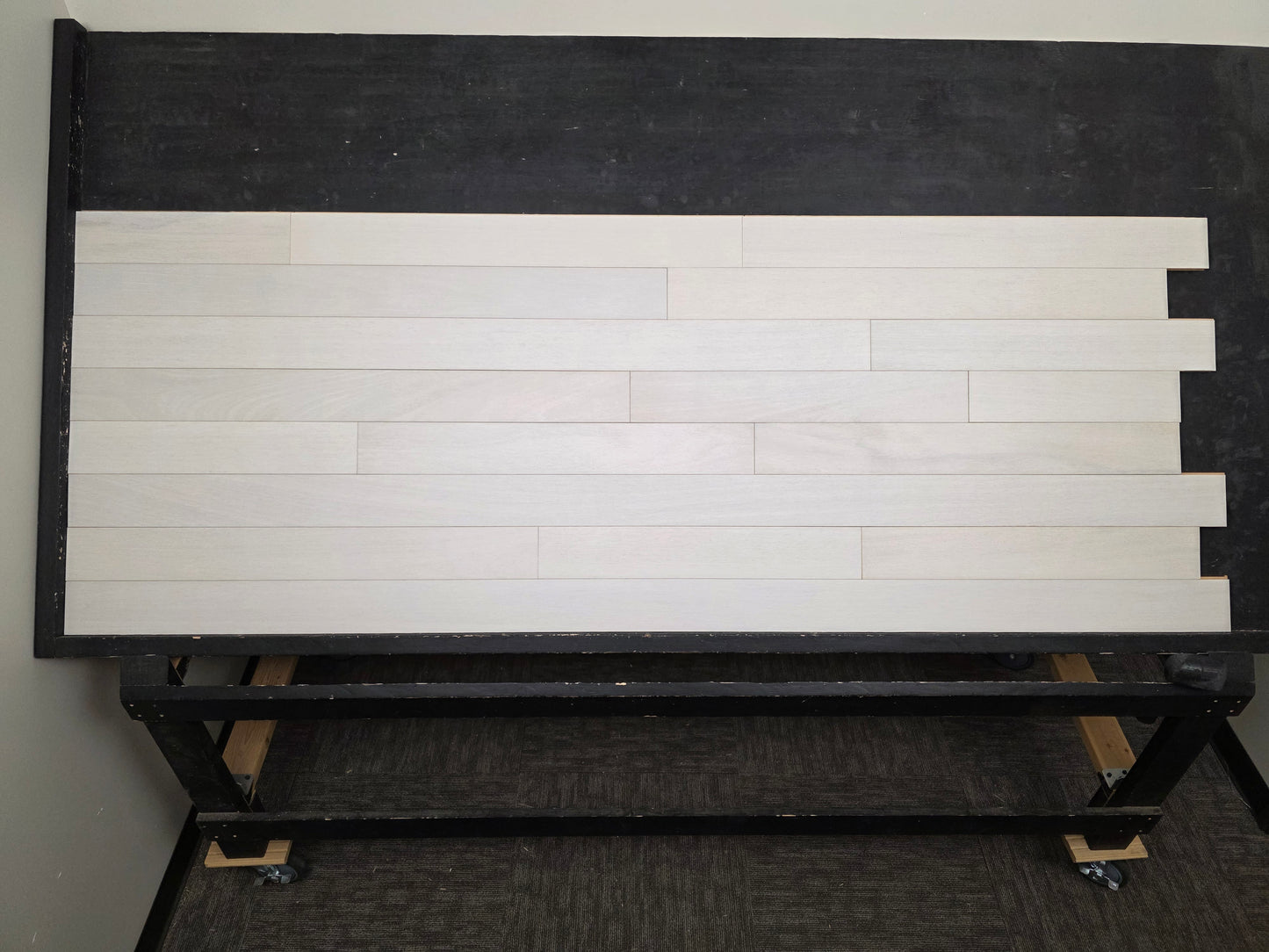 4" x 3/4" Solid Brazilian Oak Urso Hardwood Flooring on a black shooting table, head on shot.