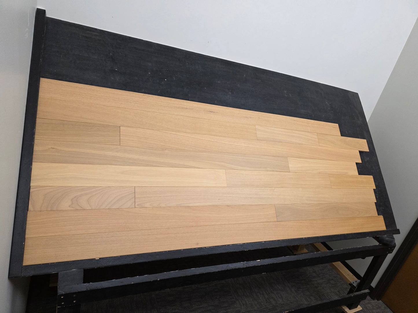4" x 3/4" Solid Brazilian Oak Natural Hardwood Flooring wide shot left hand side on a black rack