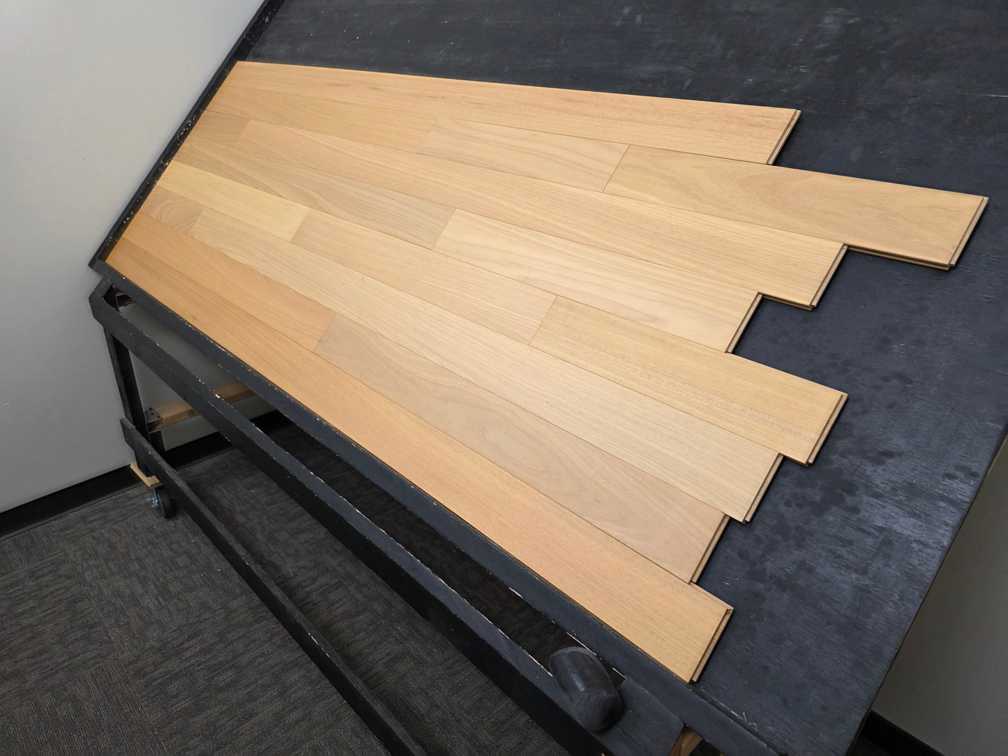4" x 3/4" Solid Brazilian Oak Natural Hardwood Flooring wide shot right angle on a black rack