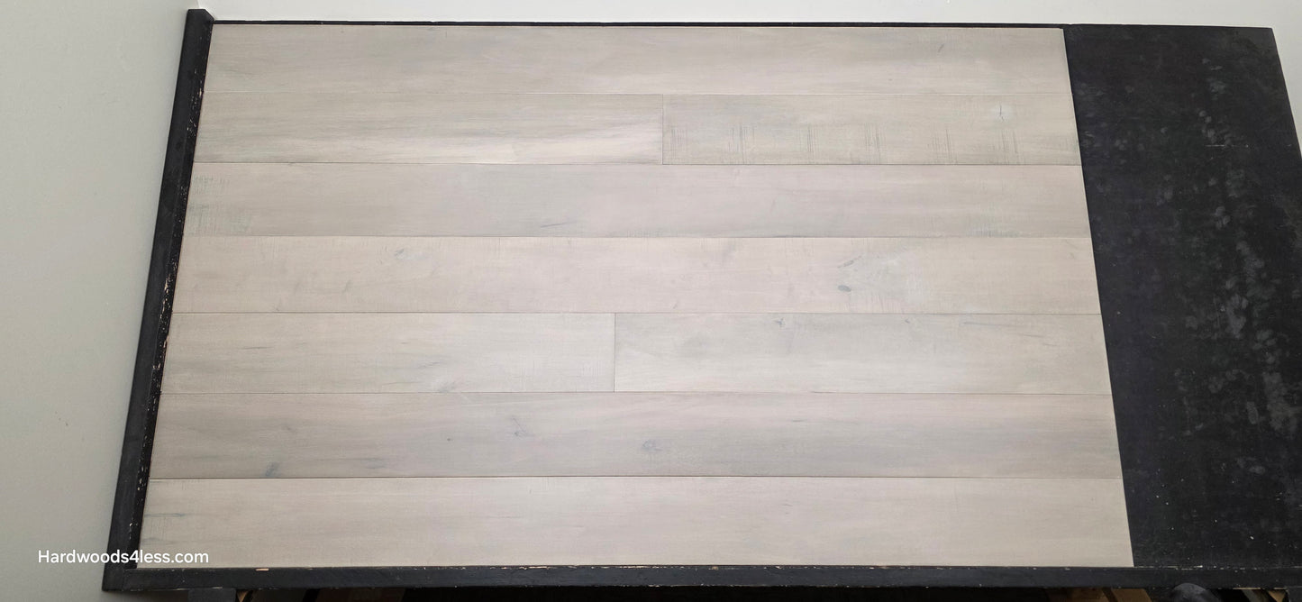 6 1/2" x 1/2" Engineered Maple Misty Moonlight Hardwood Flooring shown on a black shooting table.