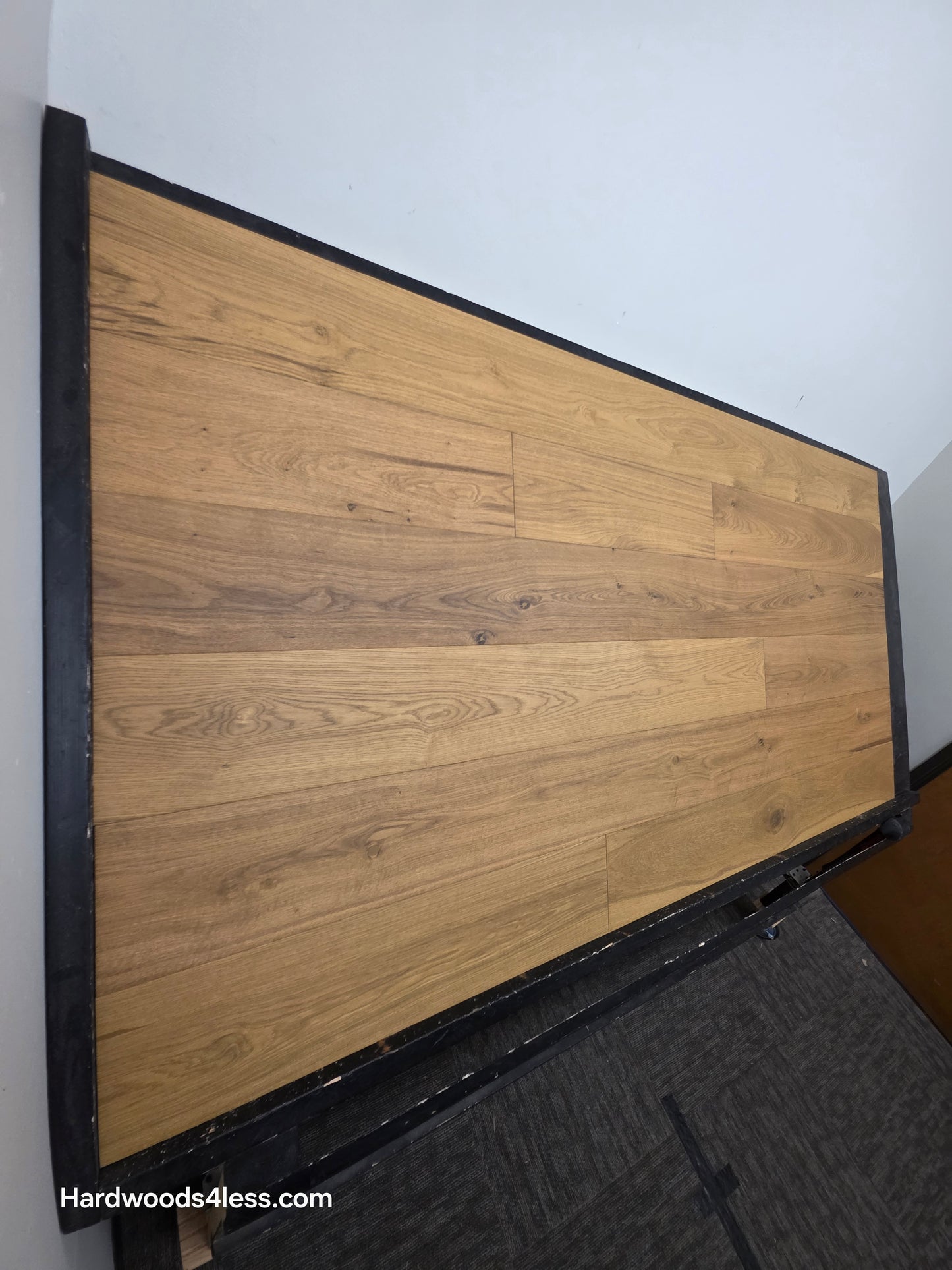 7 1/2" x 9/16" Engineered European Oak Rathlin Hardwood Flooring shown on a black shooting rack. Shot from the left hand side.