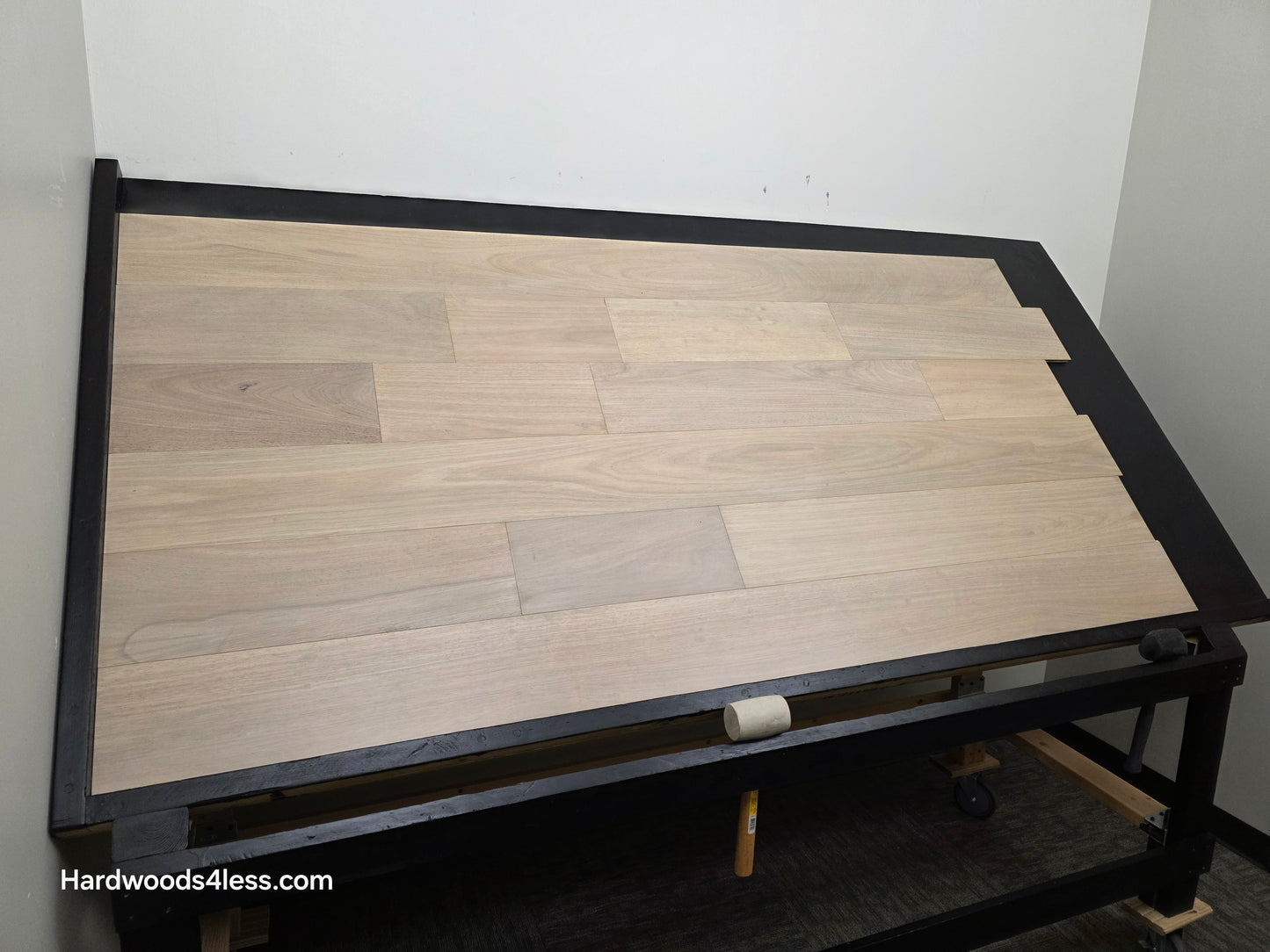 7" x 9/16" Engineered Brazilian Oak Mist Hardwood Flooring. Shown on a black shooting table. Shot from wide left.