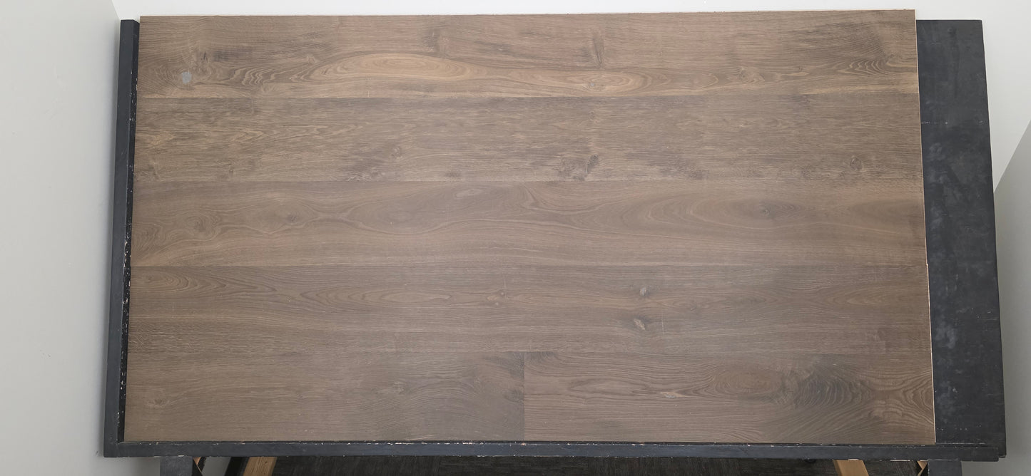 Engineered Unfinished Smoked European Oak Hardwood Flooring on a black table