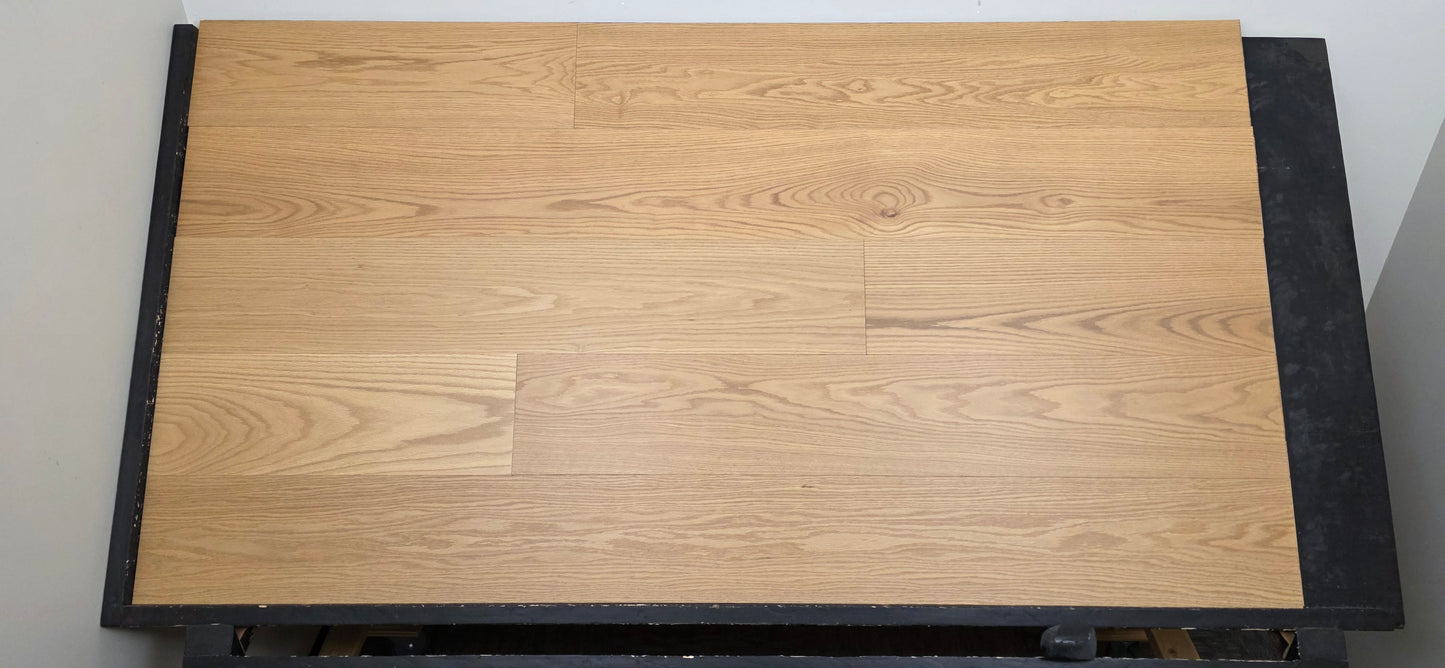 9 1/2" x 5/8" Engineered White Oak Wren Hardwood Flooring shown on a black shooting table. Head on shot.