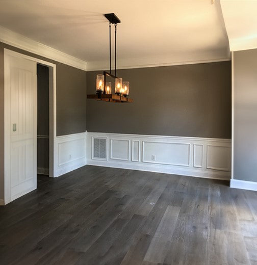 7 1/2" x 9/16" Engineered European White Oak Florence Stain Hardwood Flooring installed in a bedroom, green walls, strange chandelier on the ceiling