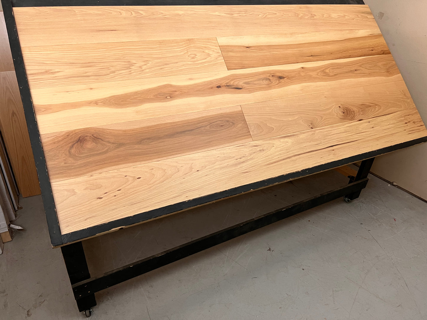 9 1/2" x 5/8" Engineered Hickory Carson (Gatlinburg) Hardwood Flooring. Shown on a black shooting table. Shot from wide left.