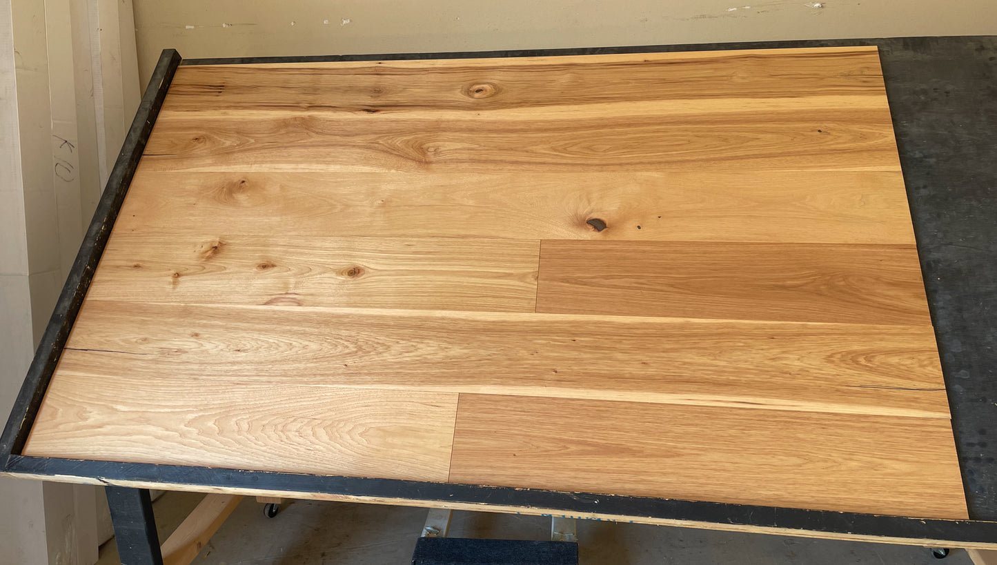7 1/2" x 1/2" Engineered Hickory Huntington Stain Hardwood Flooring on a black shooting table