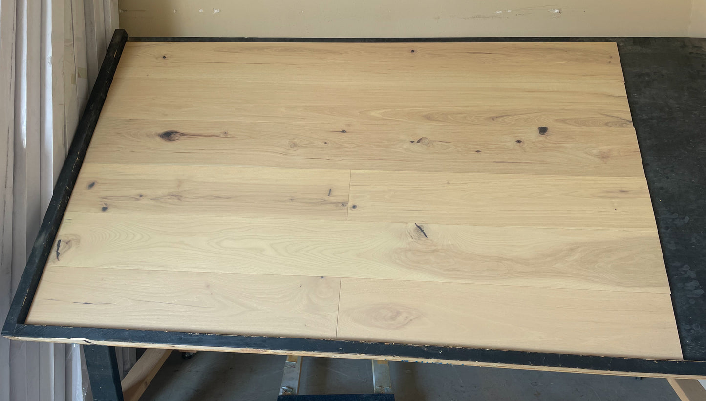 7 1/2" x 1/2" Engineered Hickory Yachats Stain Hardwood Flooring shown on a black shooting table