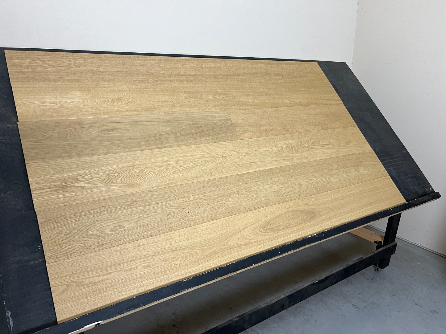 7 1/2" x 5/8" Engineered European Oak Burnet Hardwood Flooring on a black shooting table left side shot