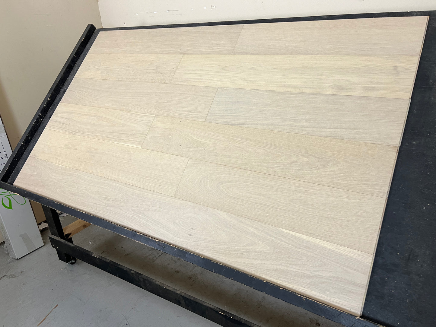 7 1/2" x 3/8" Engineered White Oak Mia Hardwood Flooring shown on a black shooting table. Shot from the left hand side.