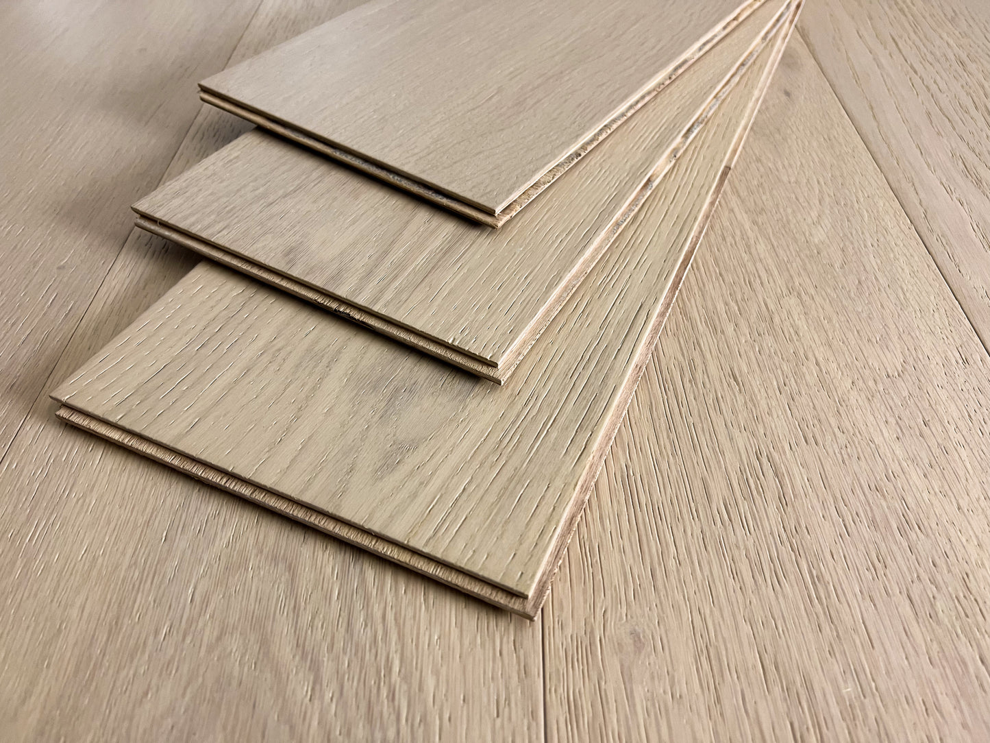 7 1/2" x 3/8" Engineered White Oak Mia Hardwood Flooring shown 3 high stacked on itself