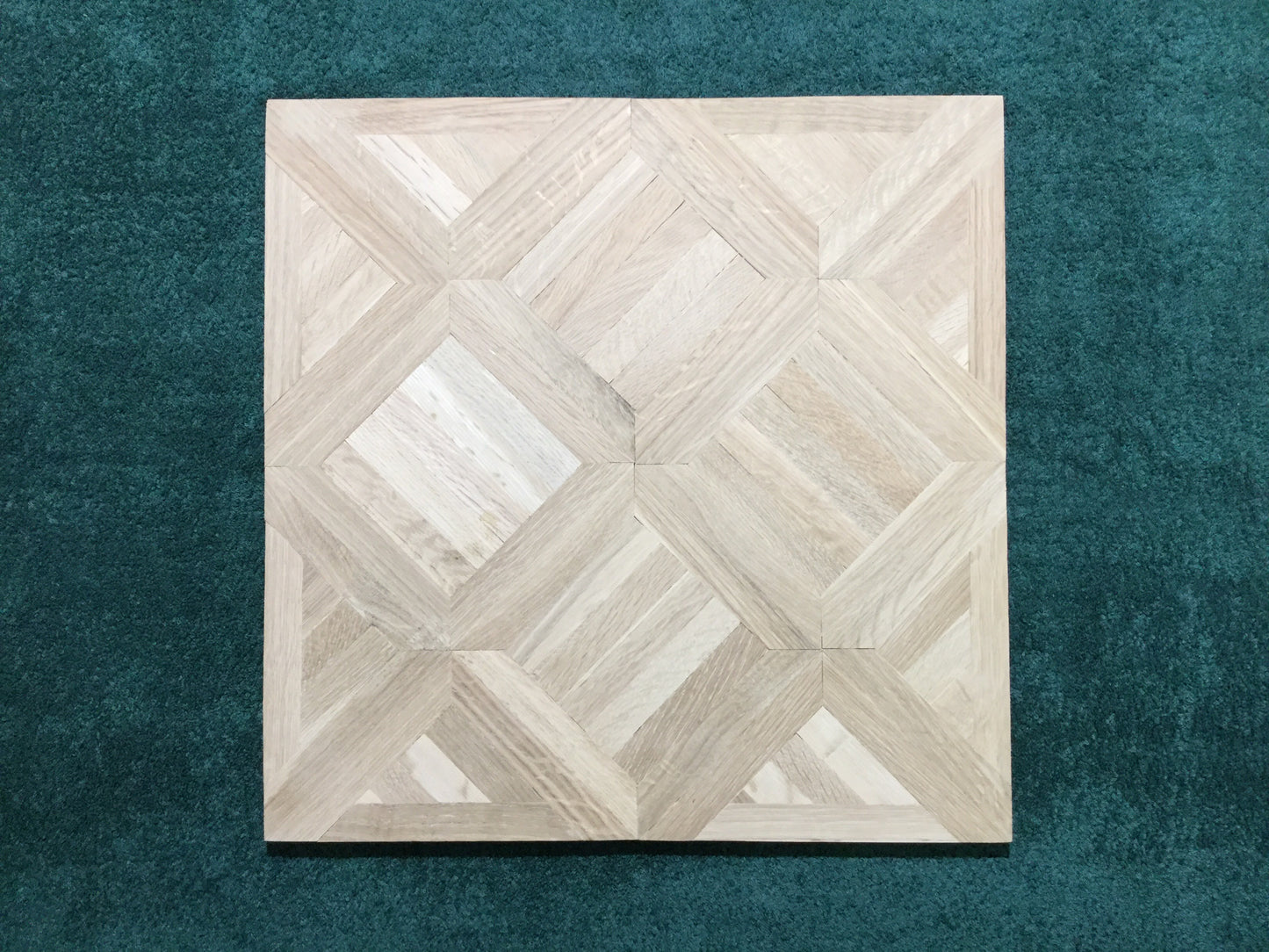 Unfinished White Oak Saxony Parquet Flooring center frame green background