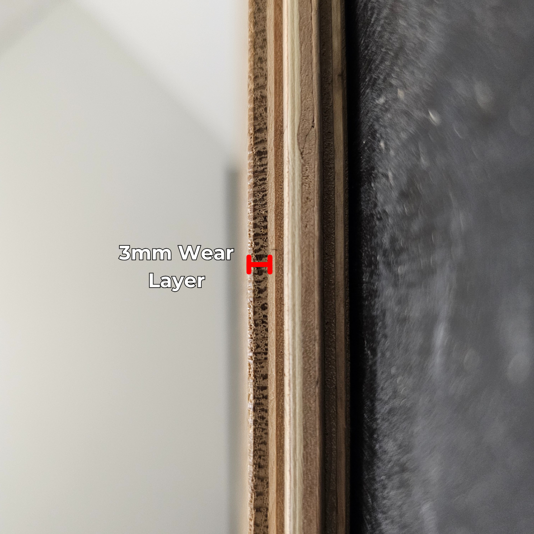 7 1/2" x 5/8" Engineered White Oak Mountain Laurel Hardwood Flooring shown close up. Center frame is a single plank on its side. This highlights the construction and wear layer.