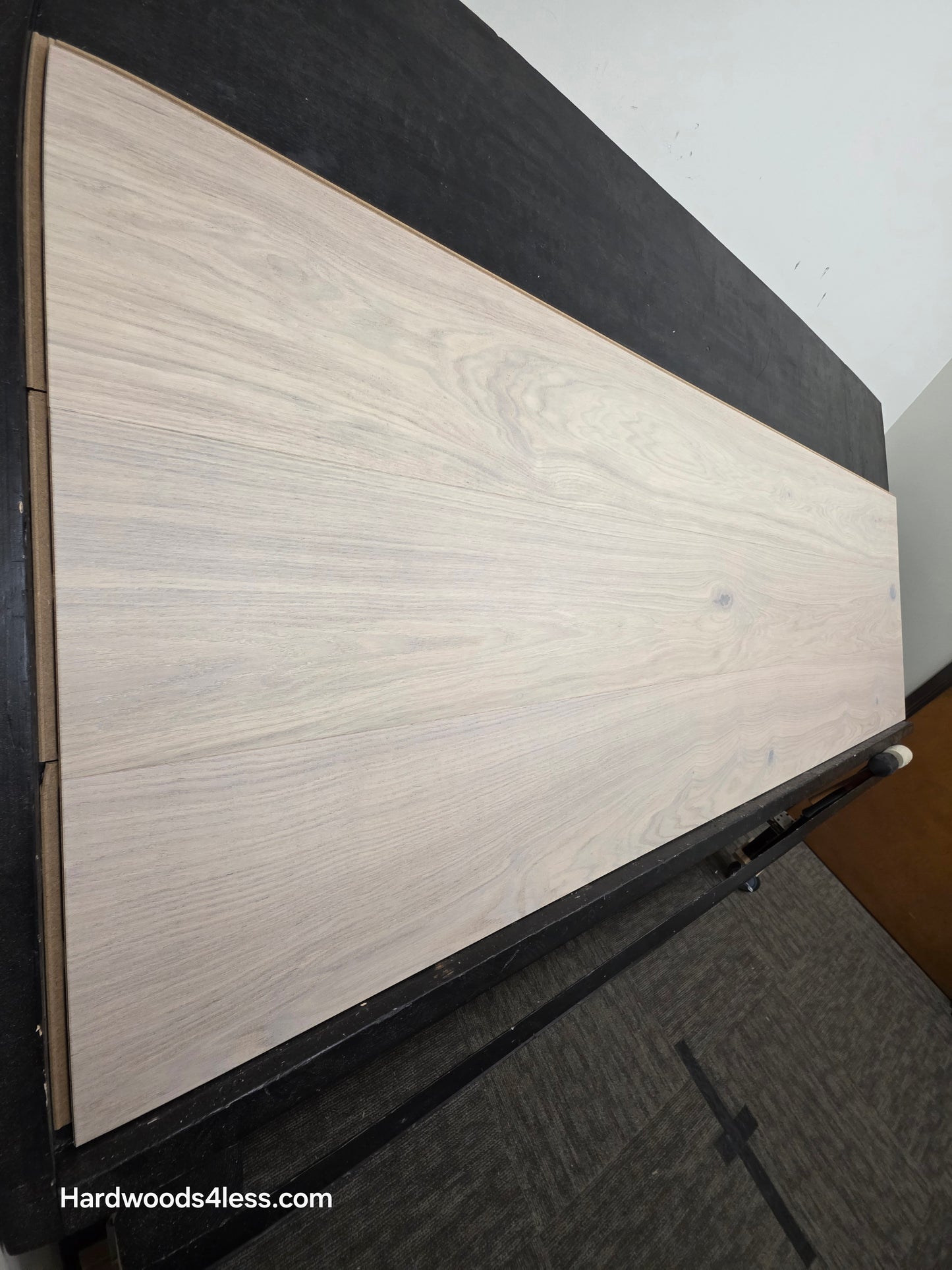 10.67" x 7/16" Modernized Engineered European Oak Corbusier Hardened Hardwood Flooring. Shown on a black shooting table. Shot from steep left.