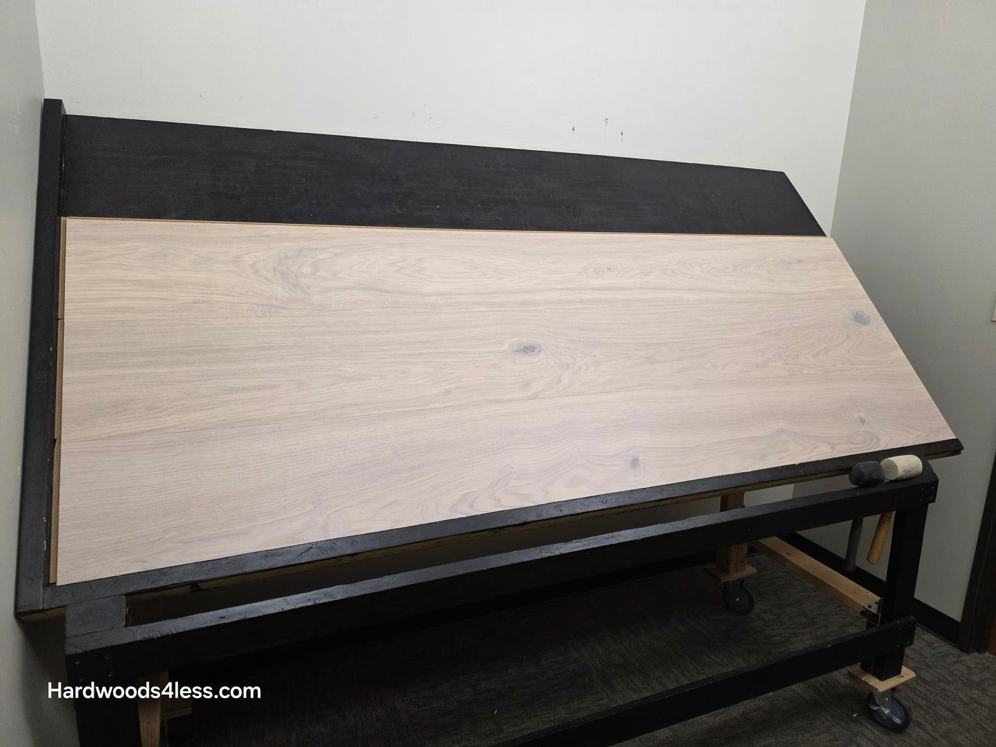 10.67" x 7/16" Modernized Engineered European Oak Corbusier Hardened Hardwood Flooring. Shown on a black shooting table. Shot from wide left.