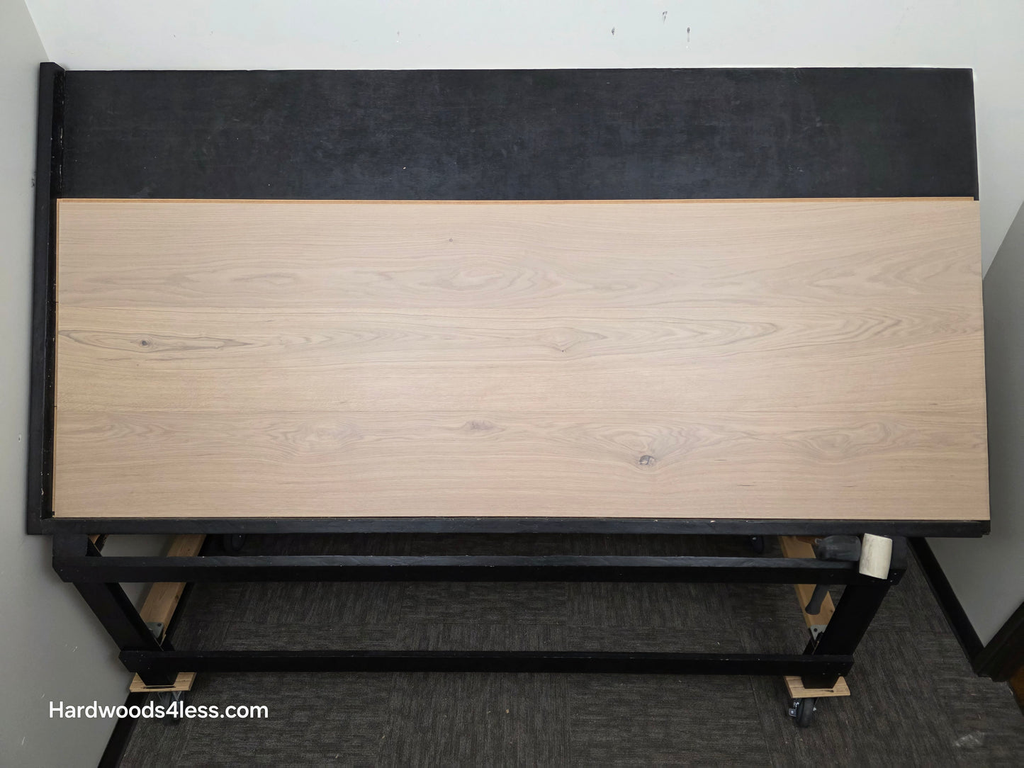 10.67" x 7/16" Modernized Engineered European Oak Foster Hardwood Flooring. Shown on a black shooting table. Shot from center. This is a Laminate look alike. 