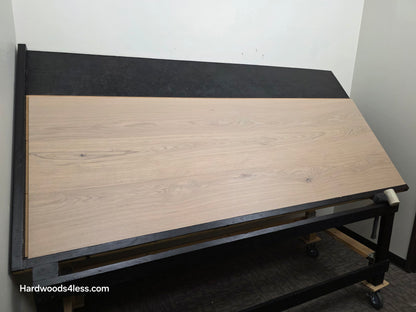 10.67" x 7/16" Modernized Engineered European Oak Foster Hardwood Flooring. Shown on a black shooting table. Shot from wide left. This is a Laminate look alike. 