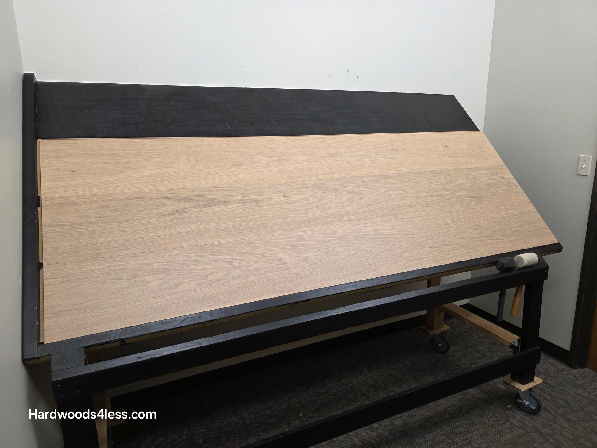 10.67" x 7/16" Modernized Engineered European Oak Gropius Hardened Hardwood Flooring. Shown on a black shooting table. Shot from wide left. 