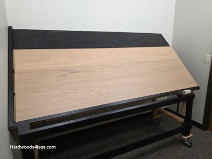 10.67" x 7/16" Modernized Engineered European Oak Gropius Hardened Hardwood Flooring. Shown on a black shooting table. Shot from wide left. 