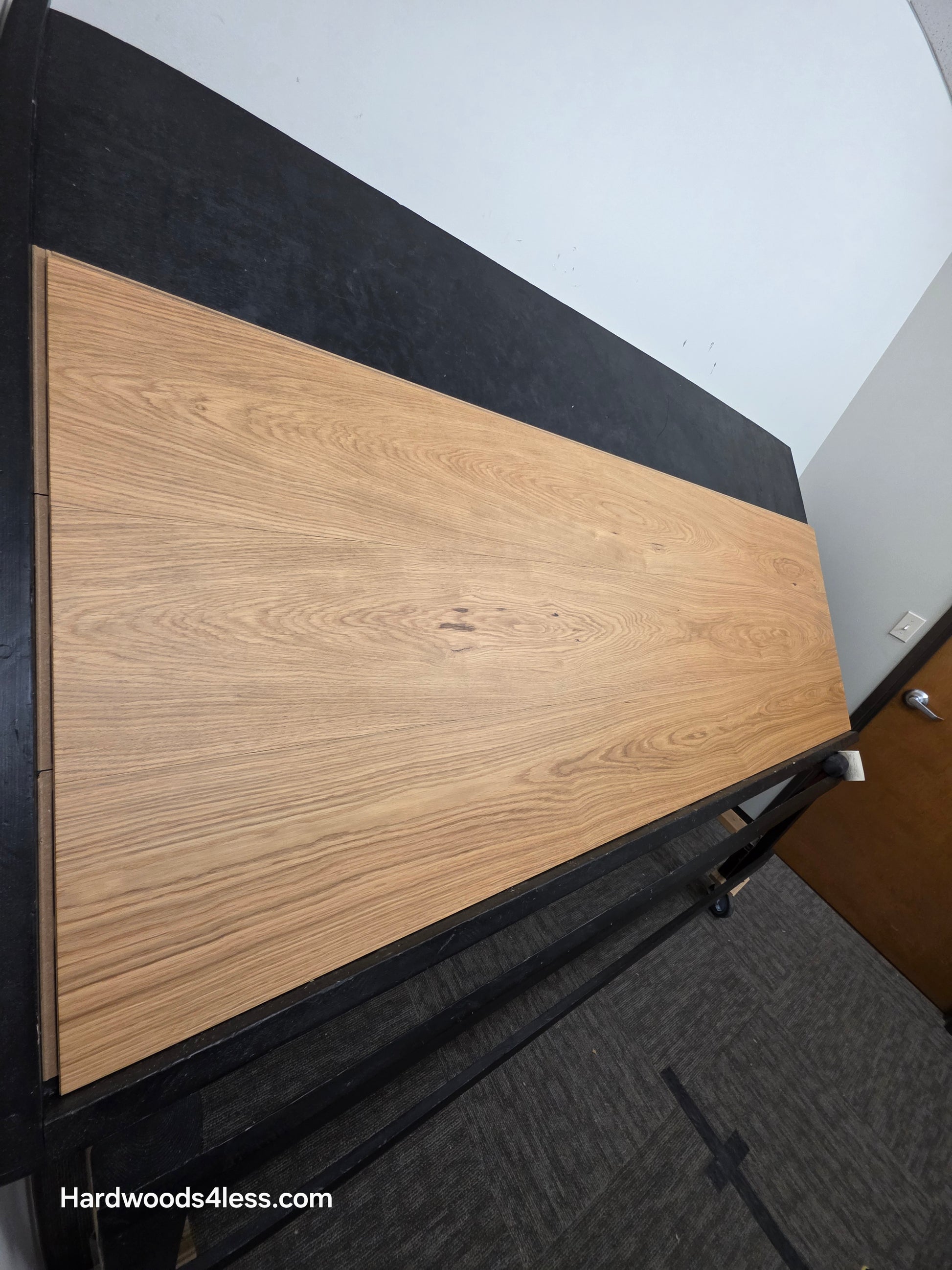 10.67" x 7/16" Modernized Engineered European Oak Hadid Hardened Hardwood Flooring.  Shown on a black shooting table. Shot from steep left.