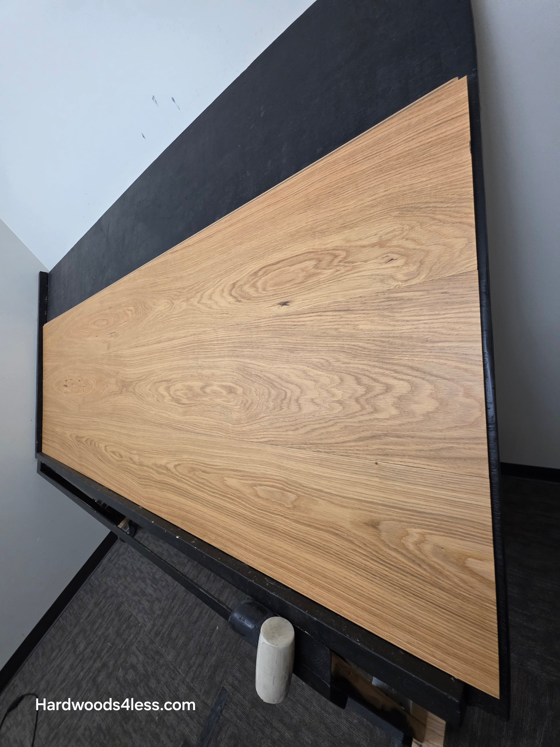 10.67" x 7/16" Modernized Engineered European Oak Hadid Hardened Hardwood Flooring.  Shown on a black shooting table. Shot from steep right.