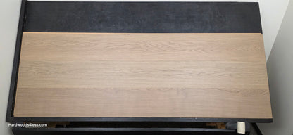 10.67" x 7/16" Modernized Engineered European Oak Khan hardened Hardwood Flooring. Shown on a black shooting table. Shot from Center.