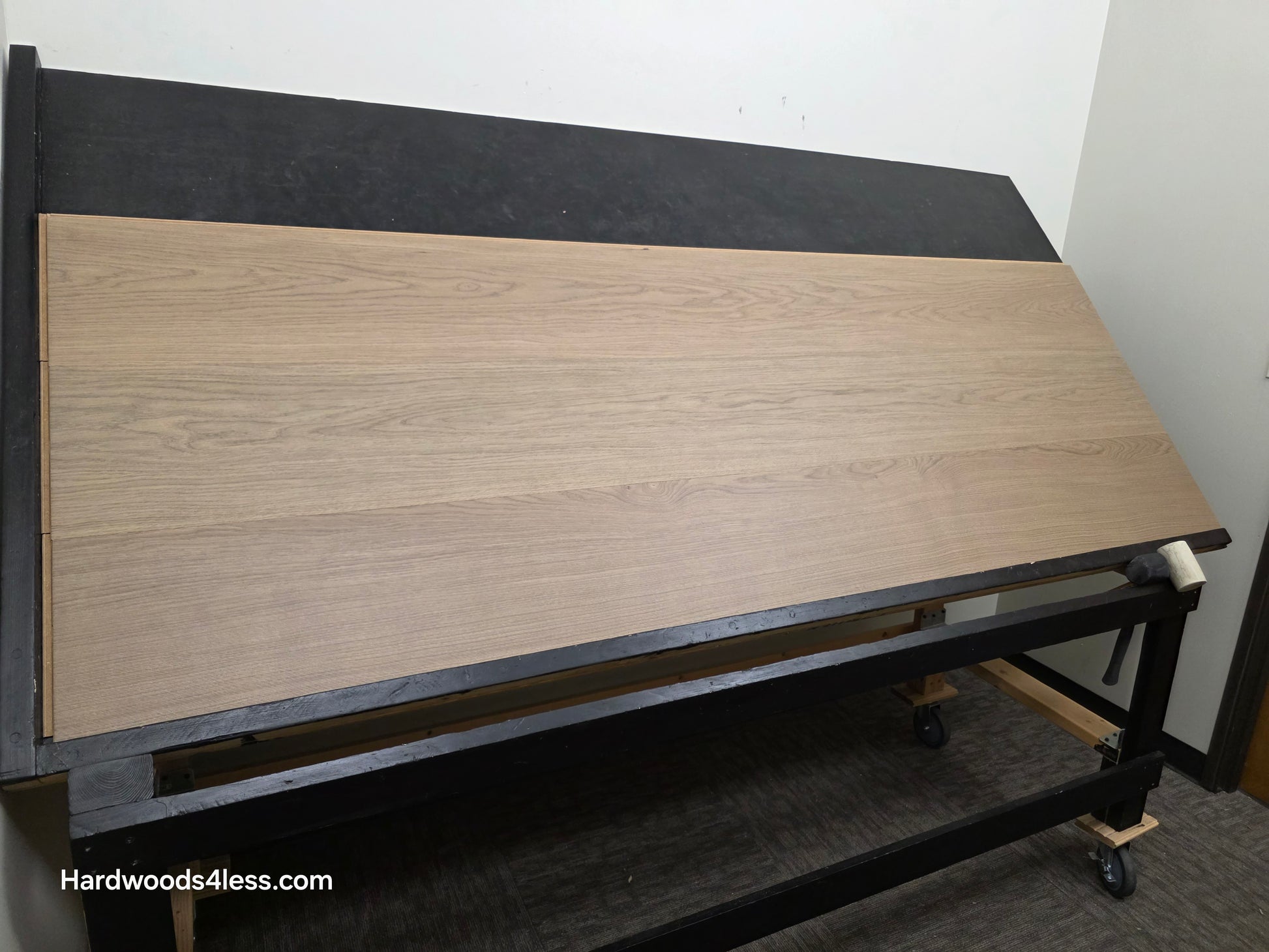 10.67" x 7/16" Modernized Engineered European Oak Khan hardened Hardwood Flooring. Shown on a black shooting table. Shot from wide left.