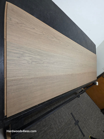 10.67" x 7/16" Modernized Engineered European Oak Khan hardened Hardwood Flooring. Shown on a black shooting table. Shot from steep left.