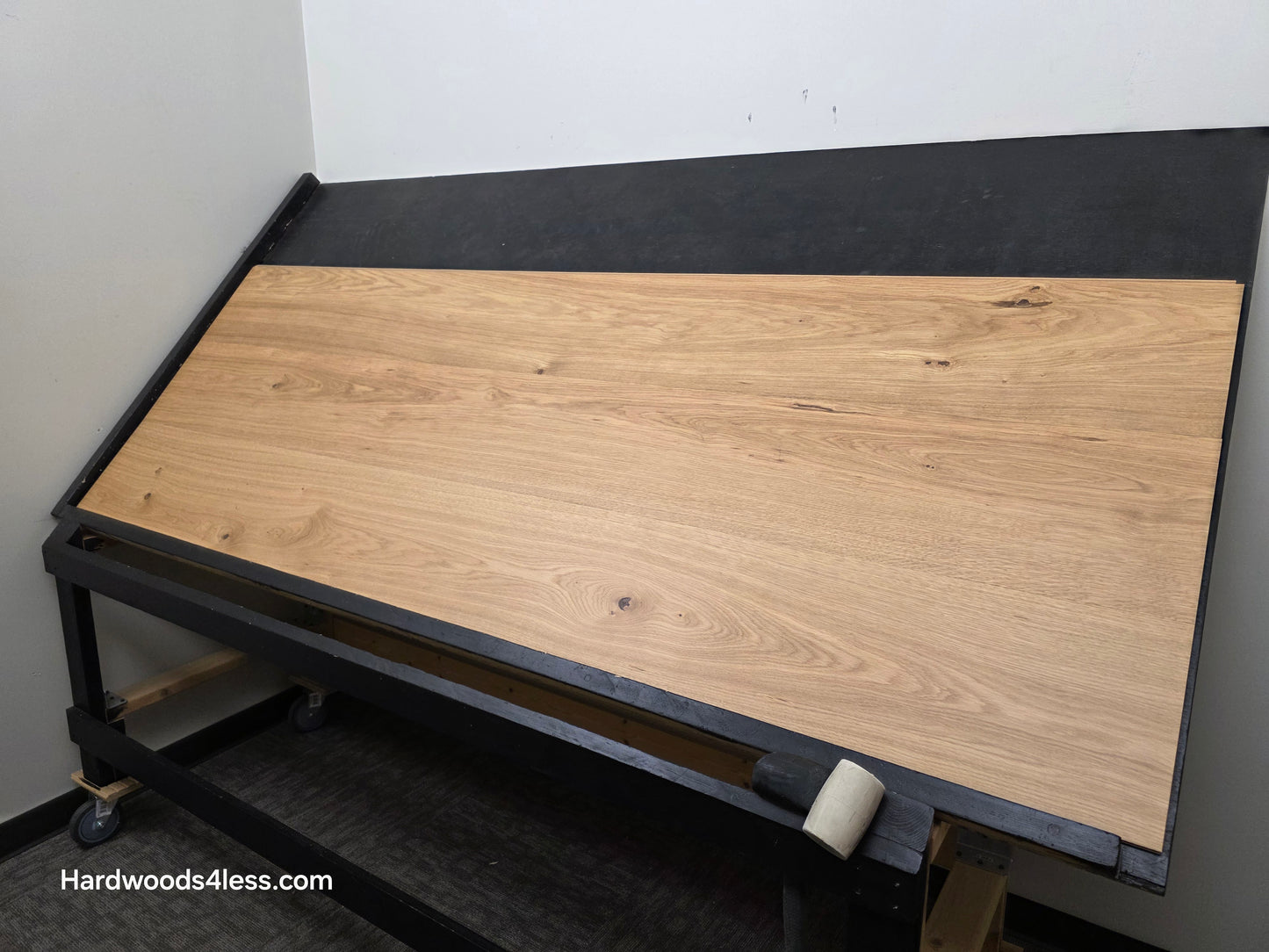 10.67" x 7/16" Modernized Engineered European Oak Wright Hardened Hardwood Flooring. Shown on a black shooting table. Shot from wide right.