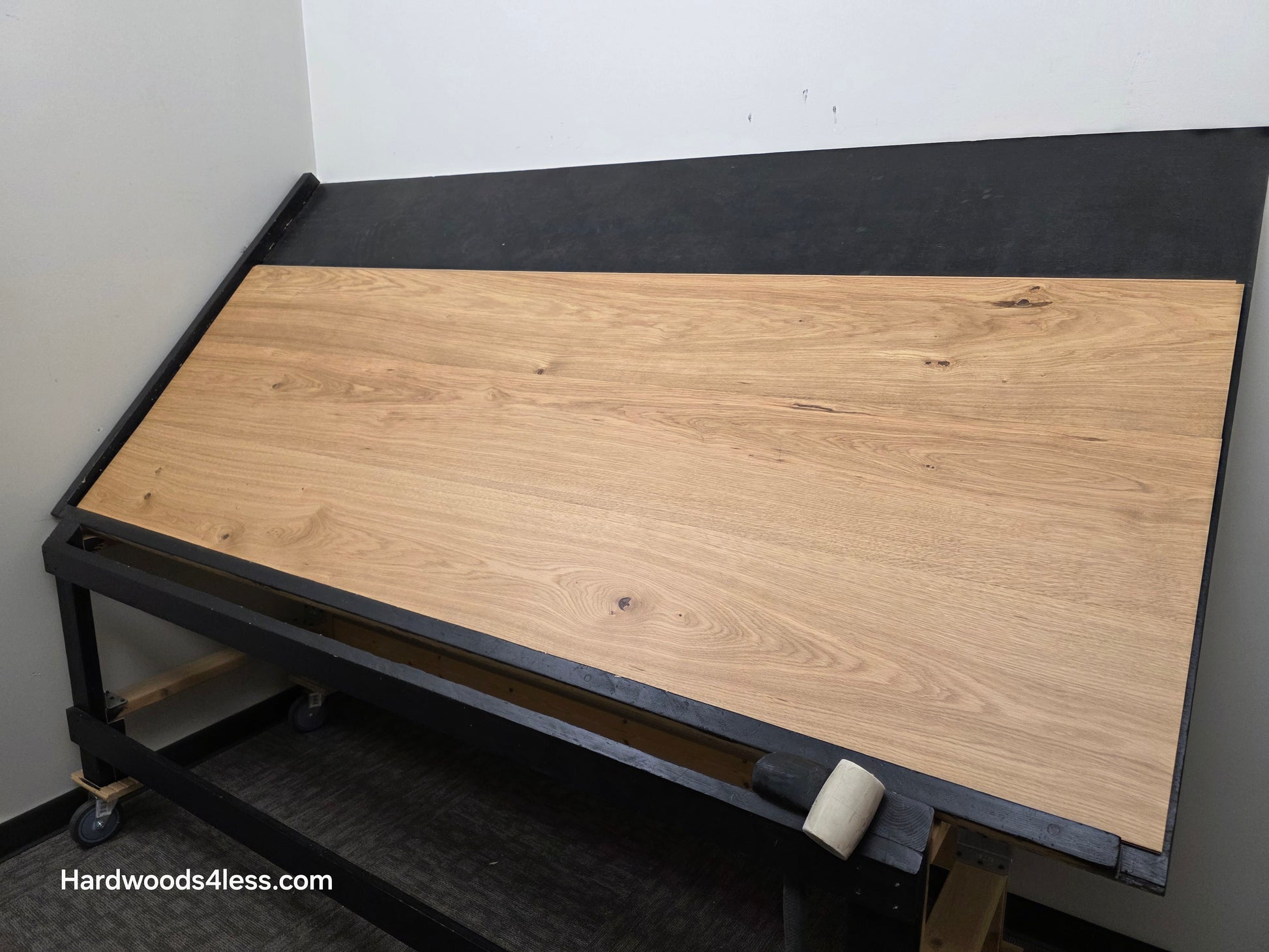 10.67" x 7/16" Modernized Engineered European Oak Wright Hardened Hardwood Flooring. Shown on a black shooting table. Shot from wide right.