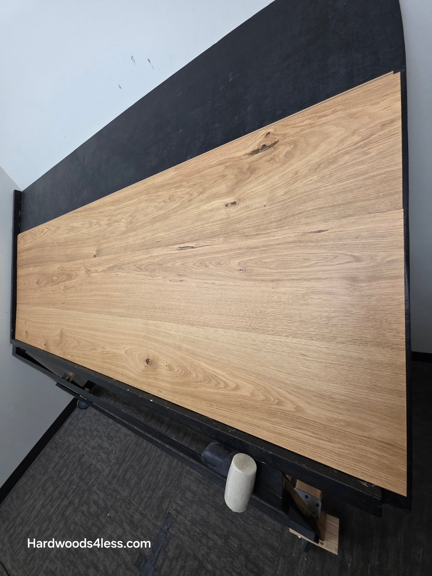 10.67" x 7/16" Modernized Engineered European Oak Wright Hardened Hardwood Flooring. Shown on a black shooting table. Shot from steep right.