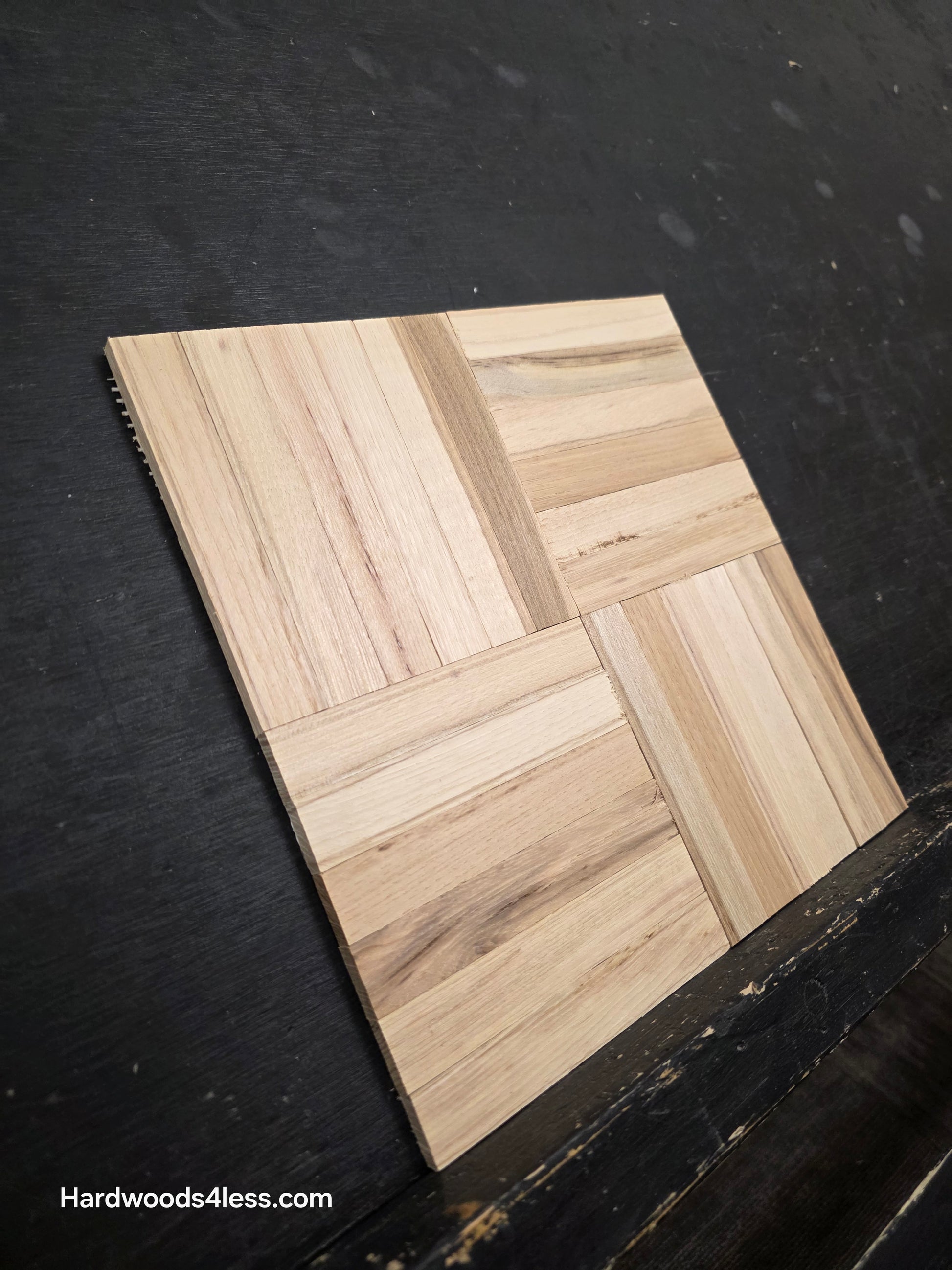 11" x 11" x 5/16" Unfinished Hickory 6-slat Parquet Hardwood Flooring. Shown on a black shooting table. Close up shot from the left side.