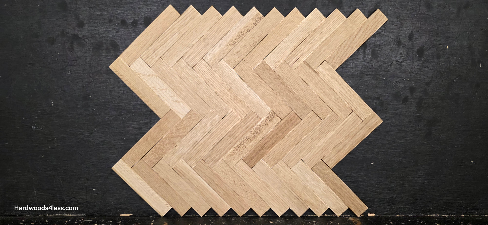 14 1/8" x 18 1/8" x 5/16" Unfinished White Oak Herringbone Parquet Flooring. 1 tile close up on a black shooting table.