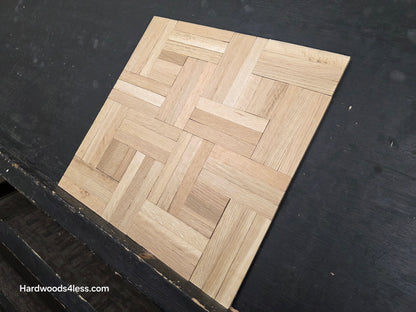 14 ¼ x 14 ¼ x 5/16 Unfinished White Oak Haddon Hall Parquet Flooring. Shown on a black shooting table. steep right hand close up. 