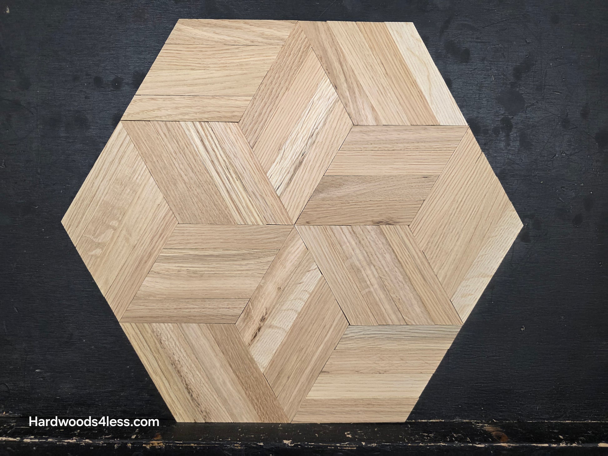 15 1/8" x 15 1/8" x 5/16" Unfinished White Oak Rhombs Parquet Flooring. Shown on a black shooting table. close up on one tile.