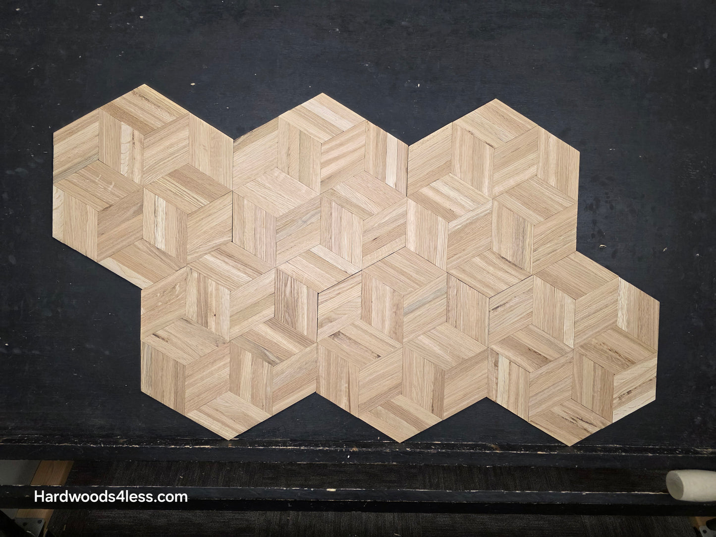 15 1/8" x 15 1/8" x 5/16" Unfinished White Oak Rhombs Parquet Flooring. Shown on a black shooting table. Shot from center. 6 tiles shown.
