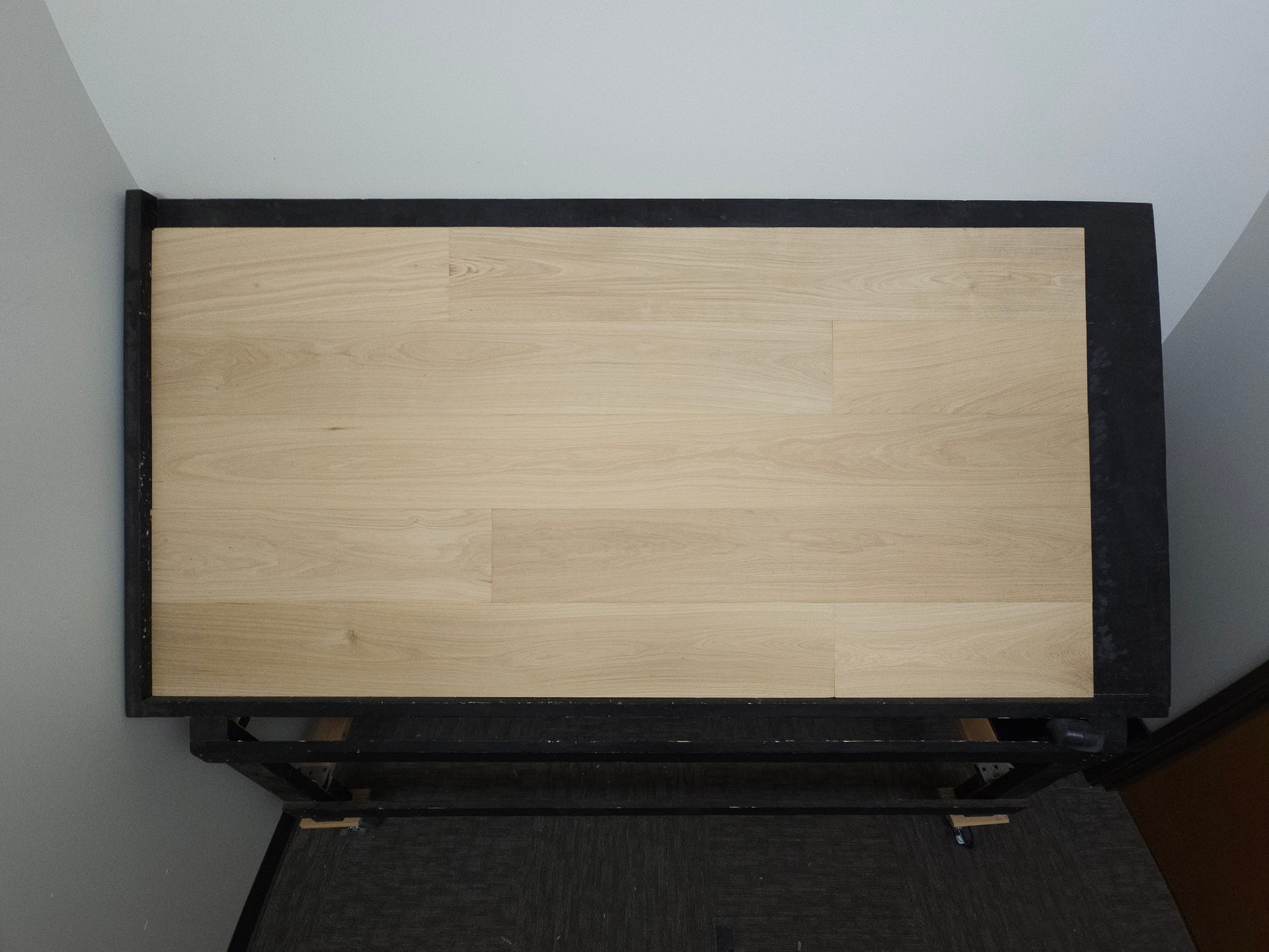 8 5/8" x 5/8" Engineered Unfinished European White Oak Select & Better Hardwood Flooring. Shown on a black shooting table. Shot from far center. 