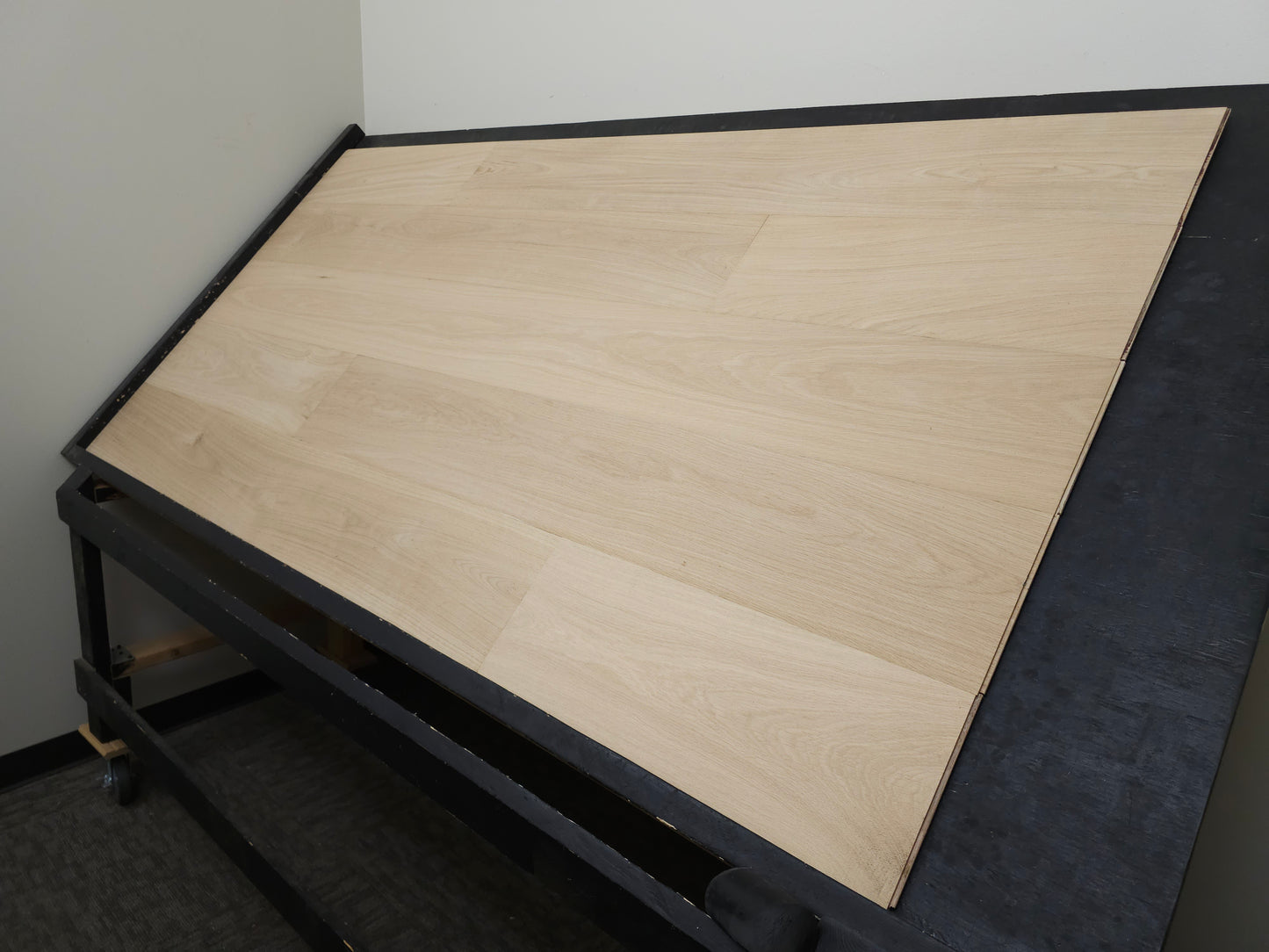 8 5/8" x 5/8" Engineered Unfinished European White Oak Select & Better Hardwood Flooring. Shown on a black shooting table. Shot from Wide right. 