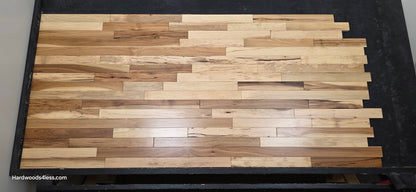 2 1/4" x 3/4" Hickory Natural Character Grade Hardwood Flooring. Shown on a black shooting table shot head on.